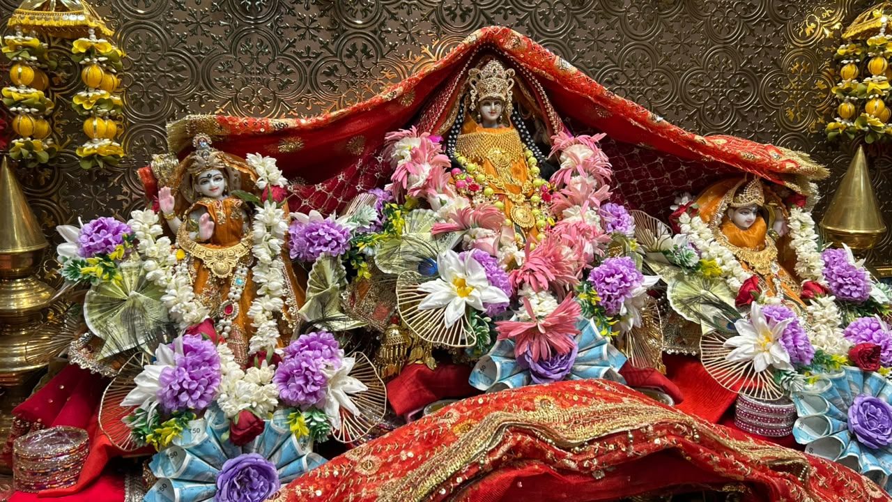 Shri Bhagwati Devi with attending deities, adorned in orange and floral garlands