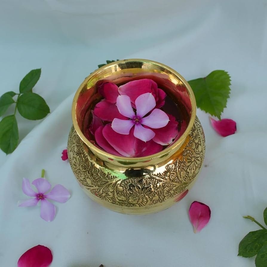 Divya Maha Aarti Jal — sacred water offered in a golden kalash with rose petals